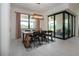 Bright dining room features a wood table, modern light fixture, and sliding glass doors to the outside patio at 6714 Alstead Cir, Bradenton, FL 34202