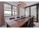 A dining room featuring a wooden table, a blue table runner and a modern light fixture above at 6714 Alstead Cir, Bradenton, FL 34202