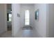 Bright entryway featuring neutral paint, tiled floors, and an abundance of natural light from the front door at 6714 Alstead Cir, Bradenton, FL 34202