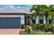 Charming single-story home with paver driveway, lush landscaping, and a neutral color palette at 6714 Alstead Cir, Bradenton, FL 34202