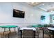 Bright game room equipped with card tables and flat-screen TVs for entertainment and relaxation at 6714 Alstead Cir, Bradenton, FL 34202
