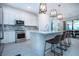 Stylish kitchen boasting white cabinetry, stainless steel appliances, a spacious island, and pendant lighting at 6714 Alstead Cir, Bradenton, FL 34202