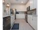 Charming kitchen features stainless steel appliances, an island, white cabinets, and a stylish tiled backsplash at 6714 Alstead Cir, Bradenton, FL 34202