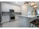 Modern kitchen with stainless steel appliances, breakfast bar, designer lighting, and stylish backsplash at 6714 Alstead Cir, Bradenton, FL 34202