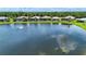 Scenic aerial view of the neighborhood lake with fountain features in an established community at 6714 Alstead Cir, Bradenton, FL 34202