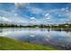 Picturesque view of the lake from the backyard showing tranquil water and blue skies at 6714 Alstead Cir, Bradenton, FL 34202