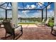 Spacious brick-paved lanai overlooking water with plenty of room for seating and relaxing at 6714 Alstead Cir, Bradenton, FL 34202