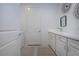 Bright laundry room with white cabinets, countertops, modern fixtures, and neutral-colored mats over tile at 6714 Alstead Cir, Bradenton, FL 34202