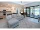 Open concept living space with modern finishes, tile flooring, and seamless access to an outdoor patio at 6714 Alstead Cir, Bradenton, FL 34202