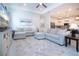 Open concept living room features light gray sectional, recessed lighting, and flows into the kitchen area at 6714 Alstead Cir, Bradenton, FL 34202
