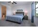 Bright main bedroom features a comfortable bed and a view of the outside at 6714 Alstead Cir, Bradenton, FL 34202