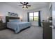 Serene main bedroom with a gray upholstered bed, side tables and lamps at 6714 Alstead Cir, Bradenton, FL 34202