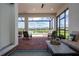 Relaxing screened patio featuring brick flooring, cozy seating, and picturesque lake views at 6714 Alstead Cir, Bradenton, FL 34202