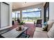 Relaxing screened patio with brick flooring, comfortable seating, and picturesque lake views at 6714 Alstead Cir, Bradenton, FL 34202