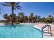 A large luxurious pool with palm trees and lounge chairs at 6714 Alstead Cir, Bradenton, FL 34202