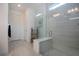 Modern shower with tiled walls, glass door, and a built in bench for added comfort at 6714 Alstead Cir, Bradenton, FL 34202