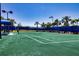 Outdoor tennis court with green playing surface and blue fencing, perfect for an active lifestyle at 6714 Alstead Cir, Bradenton, FL 34202
