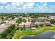 Beautiful aerial view of homes with private pools overlooking the pond in a landscaped neighborhood at 7020 Island Queen Ct, Sarasota, FL 34233