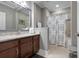Bathroom featuring a single sink vanity, framed mirror, and shower with a tub at 7020 Island Queen Ct, Sarasota, FL 34233