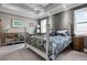 Bedroom with tray ceiling, neutral gray walls, and plantation shutters at 7020 Island Queen Ct, Sarasota, FL 34233
