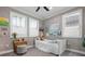 Charming bedroom features bright natural light, gray walls, and decorated with artwork at 7020 Island Queen Ct, Sarasota, FL 34233