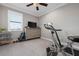 Bright workout bedroom with neutral carpet, ceiling fan, and fitness equipment at 7020 Island Queen Ct, Sarasota, FL 34233