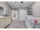 Bedroom features neutral carpet, ceiling fan, and white dresser at 7020 Island Queen Ct, Sarasota, FL 34233