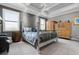 Spacious bedroom with tray ceiling, plantation shutters, and light wood furniture at 7020 Island Queen Ct, Sarasota, FL 34233