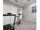 Bright workout bedroom with neutral carpet, ceiling fan, and fitness equipment at 7020 Island Queen Ct, Sarasota, FL 34233