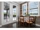 Charming breakfast nook with wood accent wall, and a view of the screened-in lanai at 7020 Island Queen Ct, Sarasota, FL 34233
