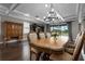 Elegant dining room featuring hardwood floors, chandelier lighting, and seamless transition to outdoor living space at 7020 Island Queen Ct, Sarasota, FL 34233