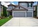Charming two-story home featuring a gray stucco exterior, red tile roof, and meticulously landscaped front yard at 7020 Island Queen Ct, Sarasota, FL 34233
