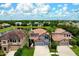 An exterior aerial view shows a two story home with a tile roof and a well manicured lawn at 7020 Island Queen Ct, Sarasota, FL 34233
