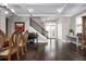 Inviting foyer featuring a staircase, piano, coffered ceilings, and elegant entryway at 7020 Island Queen Ct, Sarasota, FL 34233