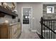 Hallway featuring decorative trim, a staircase, and an open door to the movie theater at 7020 Island Queen Ct, Sarasota, FL 34233