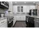 Well-lit kitchen featuring white cabinets, stainless steel appliances, and granite countertops at 7020 Island Queen Ct, Sarasota, FL 34233