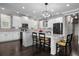 Large kitchen with modern appliances, kitchen island with seating, granite countertops and recessed lighting at 7020 Island Queen Ct, Sarasota, FL 34233