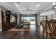 Open-concept living area featuring hardwood floors, elegant furnishings, and a view of the outdoor pool area at 7020 Island Queen Ct, Sarasota, FL 34233