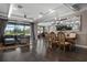 Open-concept living area featuring hardwood floors, elegant furnishings, and a view of the outdoor pool area at 7020 Island Queen Ct, Sarasota, FL 34233