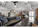 Open-concept living area with kitchen and dining area, featuring hardwood floors and ample natural light at 7020 Island Queen Ct, Sarasota, FL 34233