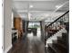 Spacious living room featuring hardwood floors, coffered ceilings, and a seamless transition to outdoor living space at 7020 Island Queen Ct, Sarasota, FL 34233