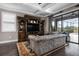 Comfortable living room with a large couch, custom shelving, and beautiful pool views at 7020 Island Queen Ct, Sarasota, FL 34233