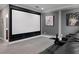 Home movie theater with a large screen, comfortable seating, and custom wall art at 7020 Island Queen Ct, Sarasota, FL 34233