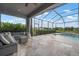 Screened patio with luxury outdoor furniture and view of the pool and backyard at 7020 Island Queen Ct, Sarasota, FL 34233