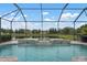 Relaxing screened pool featuring a water feature with beautiful views of the pond at 7020 Island Queen Ct, Sarasota, FL 34233