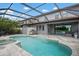 Spacious screened in pool area featuring a large pool with an outdoor kitchen and seating at 7020 Island Queen Ct, Sarasota, FL 34233