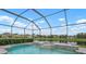 A serene pool setting with a water feature and a tranquil view of the pond at 7020 Island Queen Ct, Sarasota, FL 34233