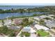 Stunning aerial view of a waterfront property with a private pool and lush landscaping at 715 Fontana Ln, Bradenton, FL 34209