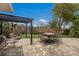 Charming backyard with a paved patio, pergola, and lush lawn, perfect for outdoor dining and relaxation at 715 Fontana Ln, Bradenton, FL 34209