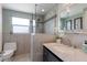 Elegant bathroom showcasing a glass-enclosed shower, tiled walls, and a vanity with marble top at 715 Fontana Ln, Bradenton, FL 34209